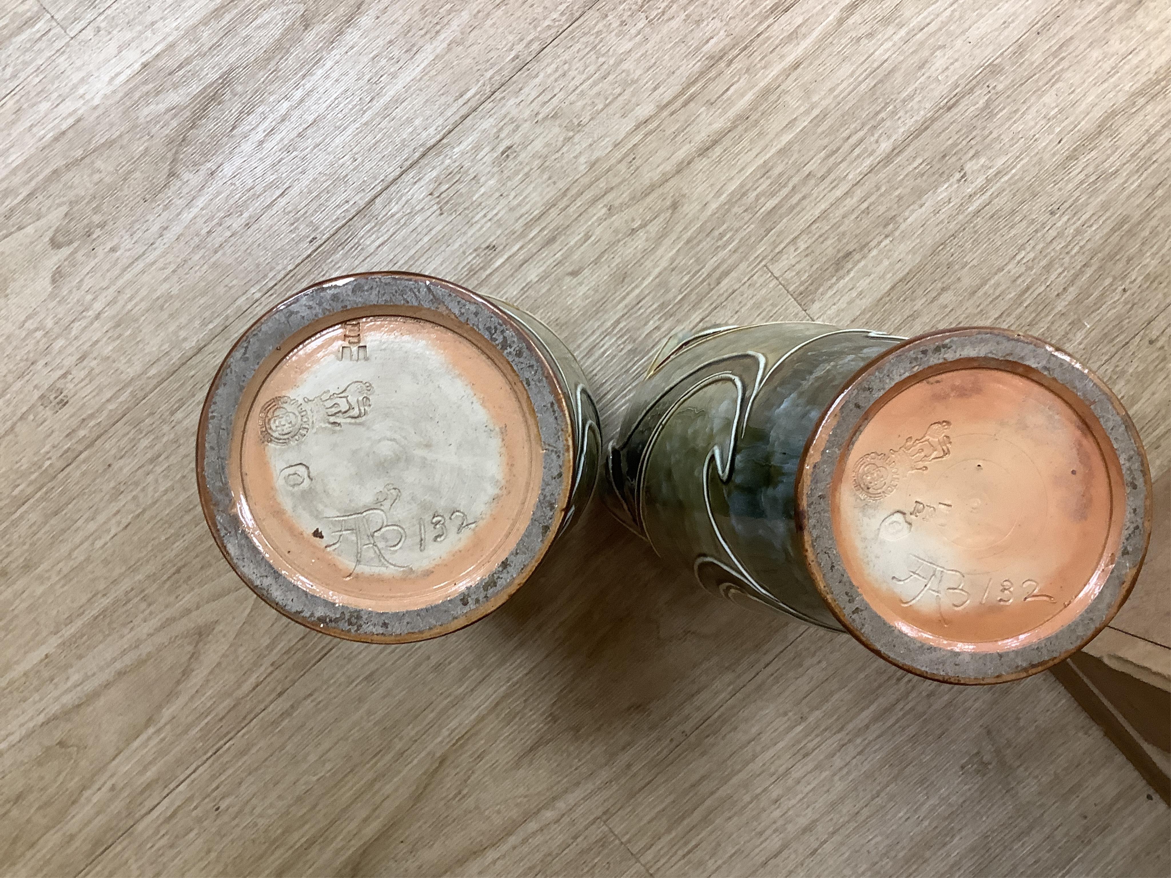 A pair of Royal Doulton, Art Nouveau vases by Frank Butler, incised and impressed marks to the bases, 37cm high